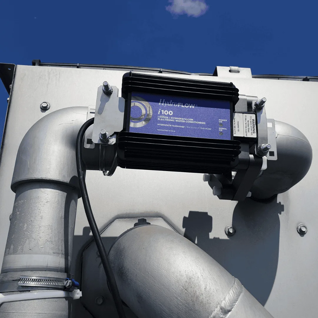 A QEQI® unit installed around a grey water pipe, with no cutting and no chemicals