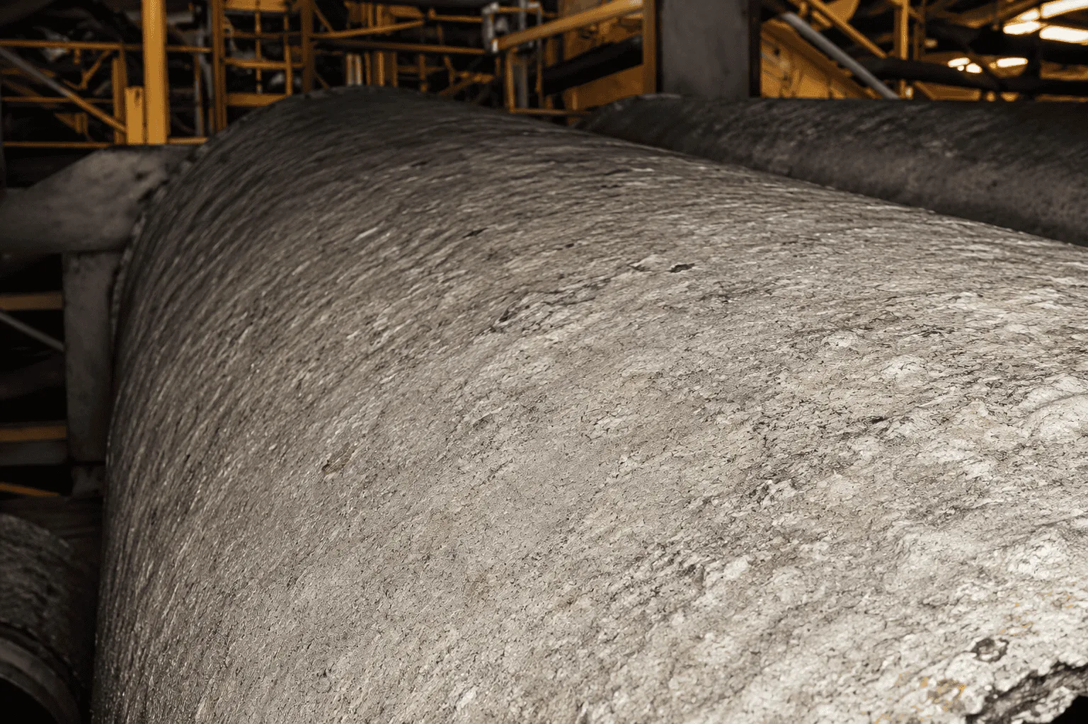 Belt press drum coated in hard struvite scale bridging the drum holes, before QEQI® treatment — Water Conserv II Water Reclamation Facility, Orlando, Florida