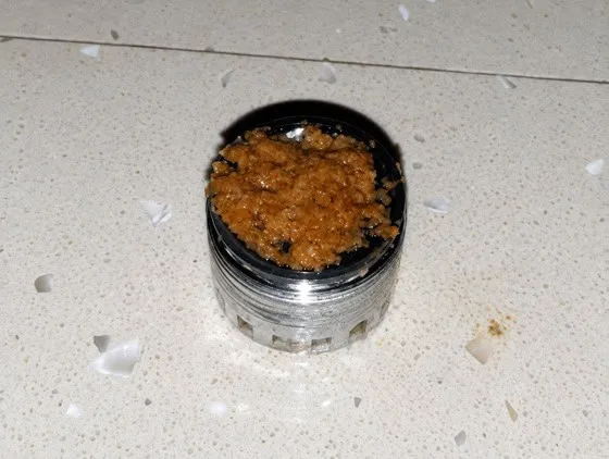 Tap jet breaker completely blocked by orange-brown biofilm before QEQI® treatment — Grand Hotel Terme di Comano, Trentino, Italy